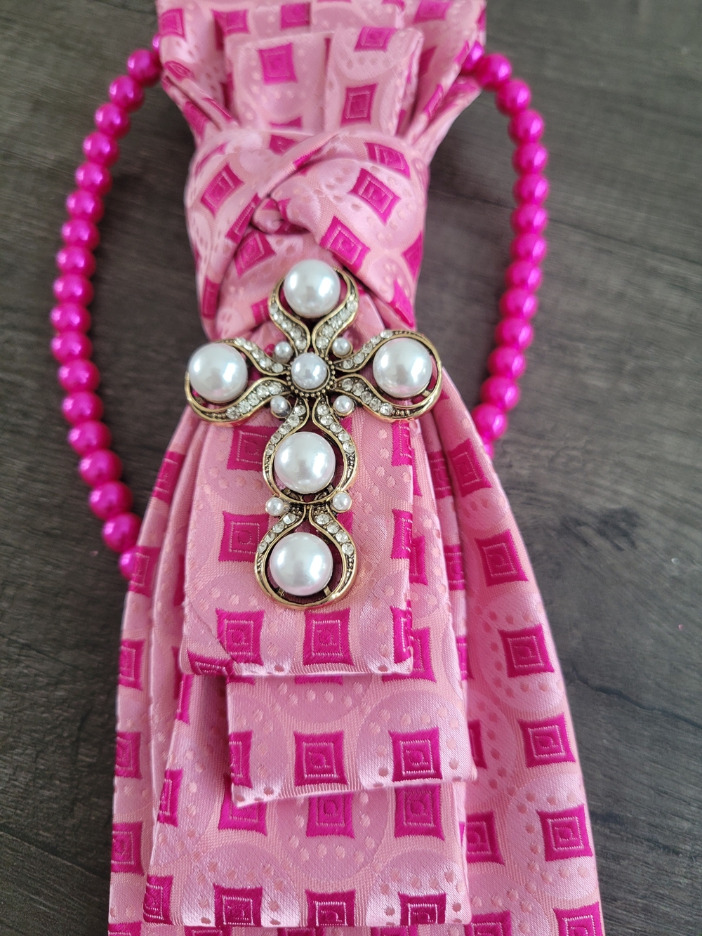 Pearl and Rhinestone Cross Brooch on Pink Patterned Necktie